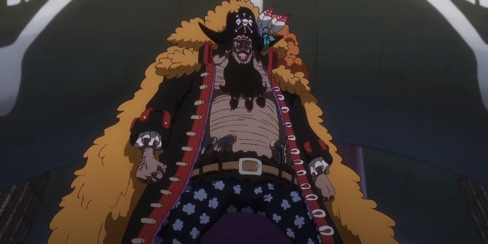 Blackbeard standing with a large coat with a smile on his face 