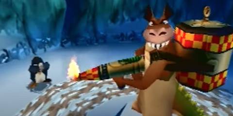 Dingodile aiming a flamethrower at a penguin in Crash Bandicoot 3: Warped
