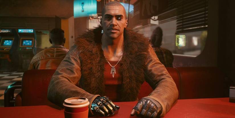 River sitting down with a cup 