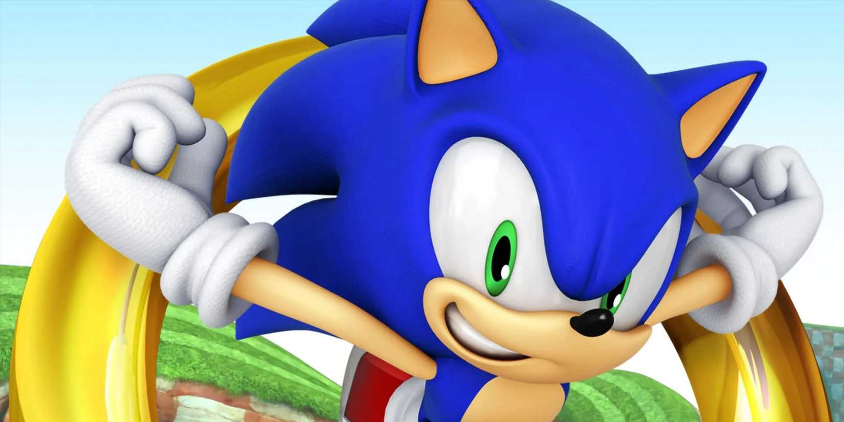 A promotional image of Sonic the Hedgehog racing along Green Hill Zone with a giant ring behind him.