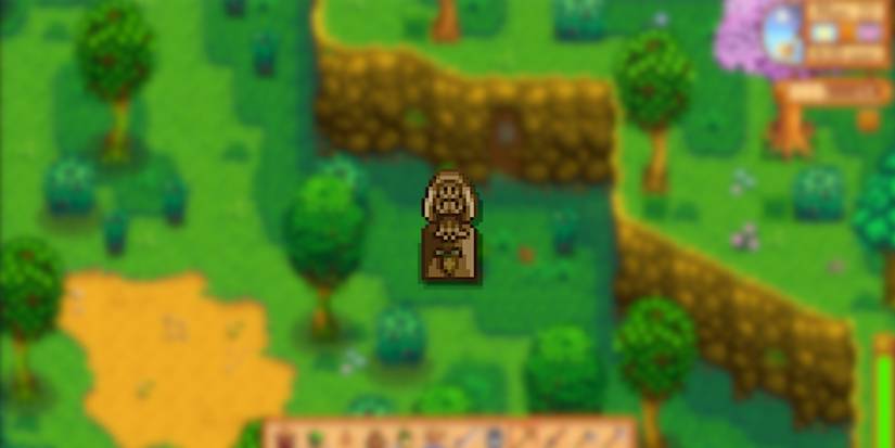 Image of the Statue of Blessings in the foreground and the Mastery Cave entrance in the background in Stardew Valley