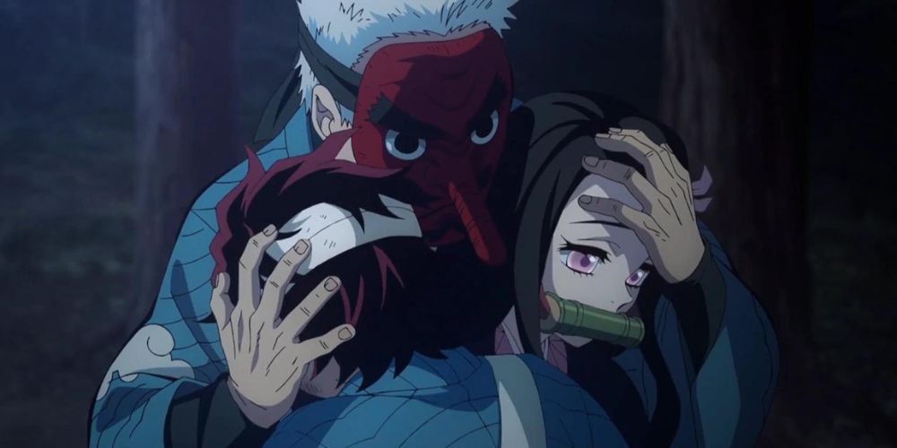 Urokodaki embracing Tanjiro and Nezuko.