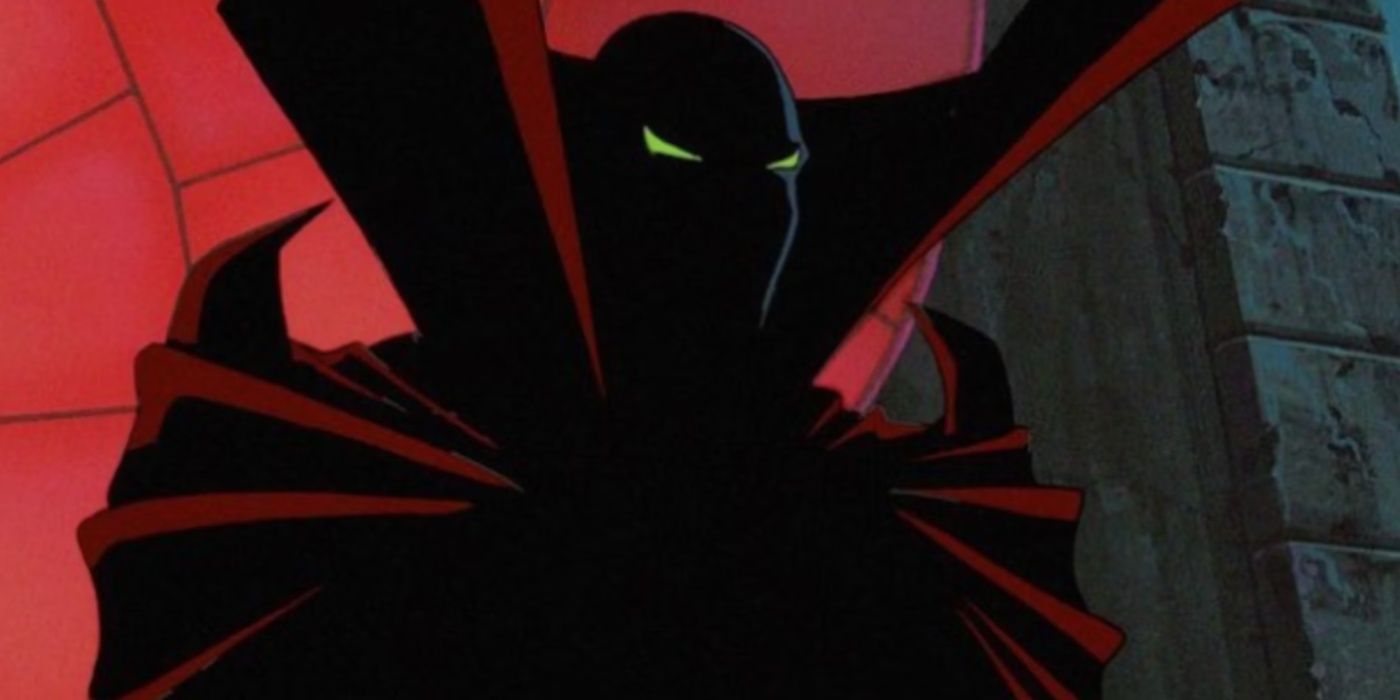 A dark figure with green eyes and a red cape in Spawn
