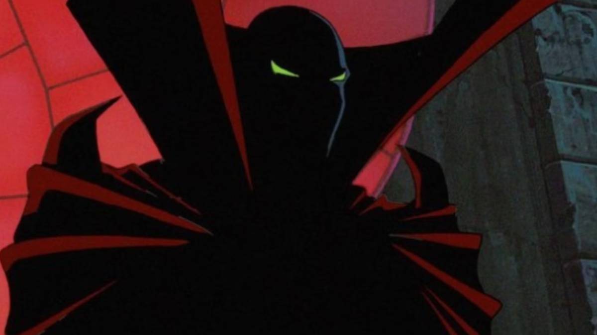 A dark figure with green eyes and a red cape in Spawn