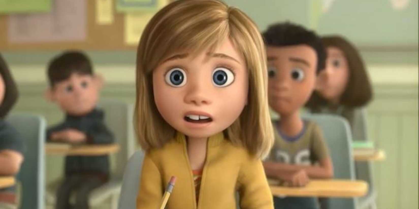 Riley sitting in a classroom at school in Inside Out