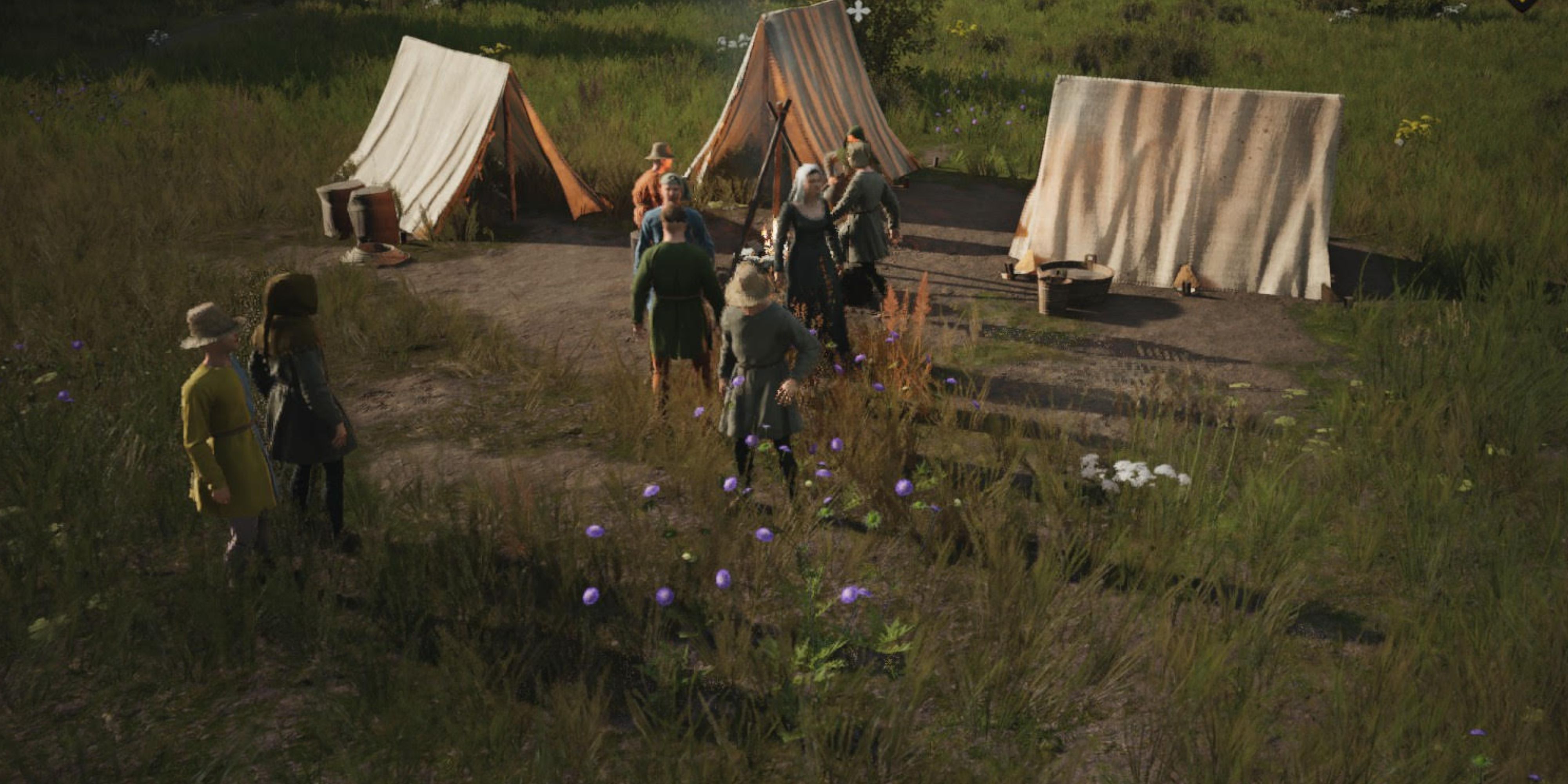 A group of workers outside some tents in Manor Lords