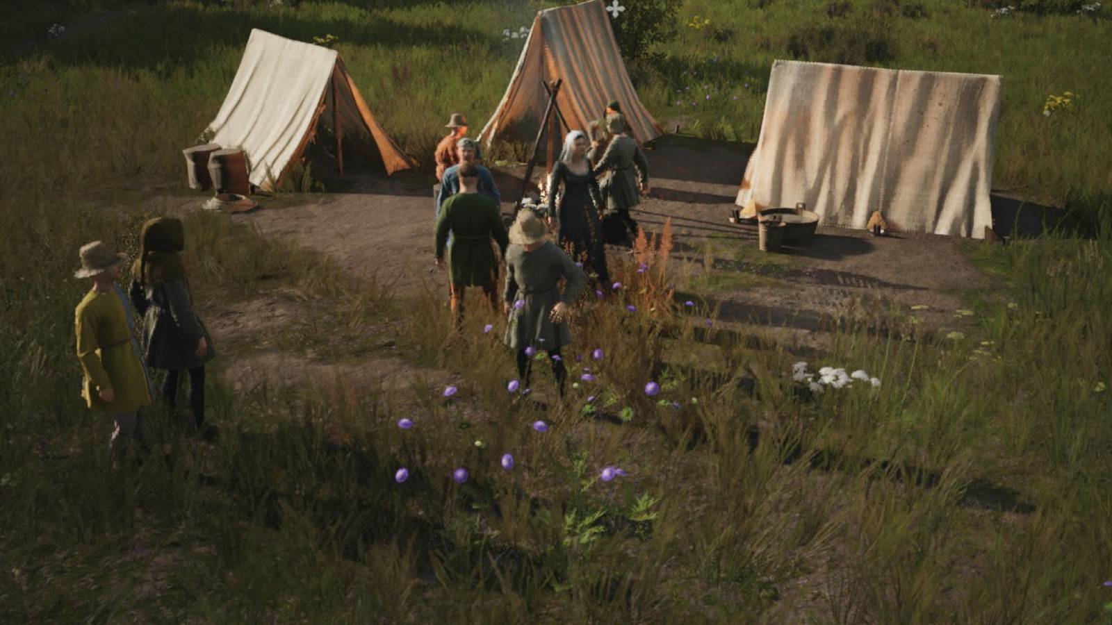 A group of workers outside some tents in Manor Lords