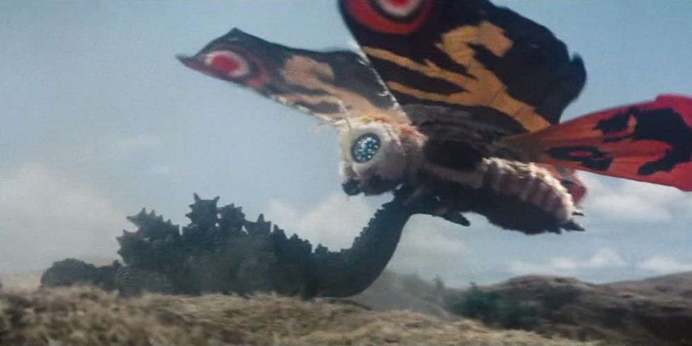 Mothra dragging Godzilla by the tail.
