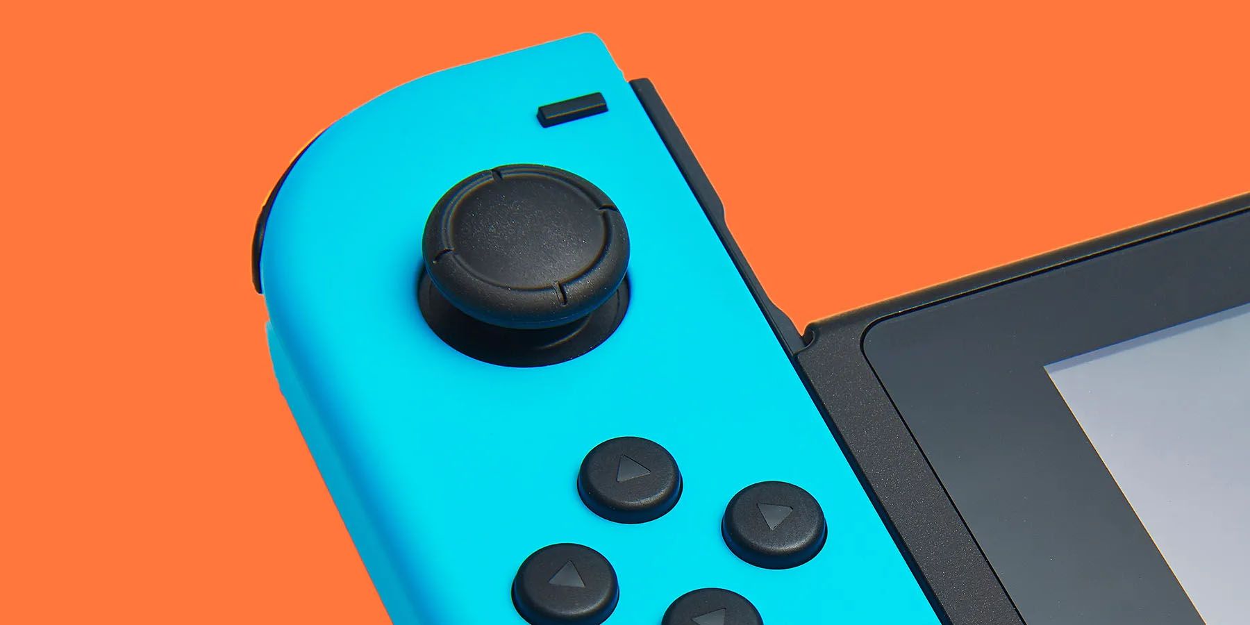 A close-up image of a blue Nintendo Joy-Con controller against an orange background.