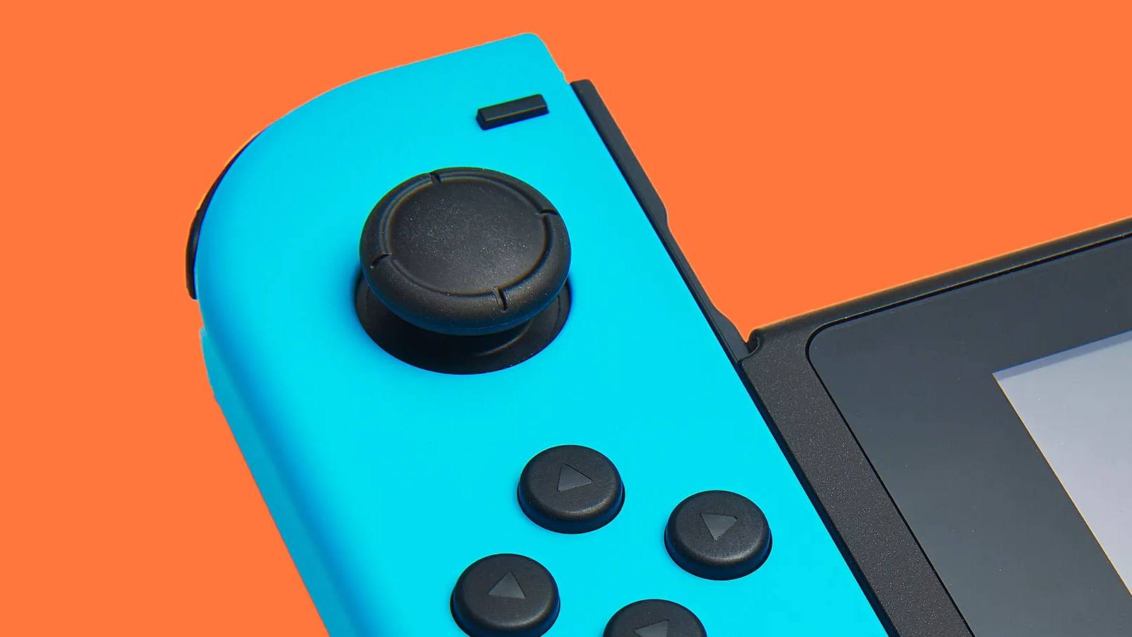 A close-up image of a blue Nintendo Joy-Con controller against an orange background.