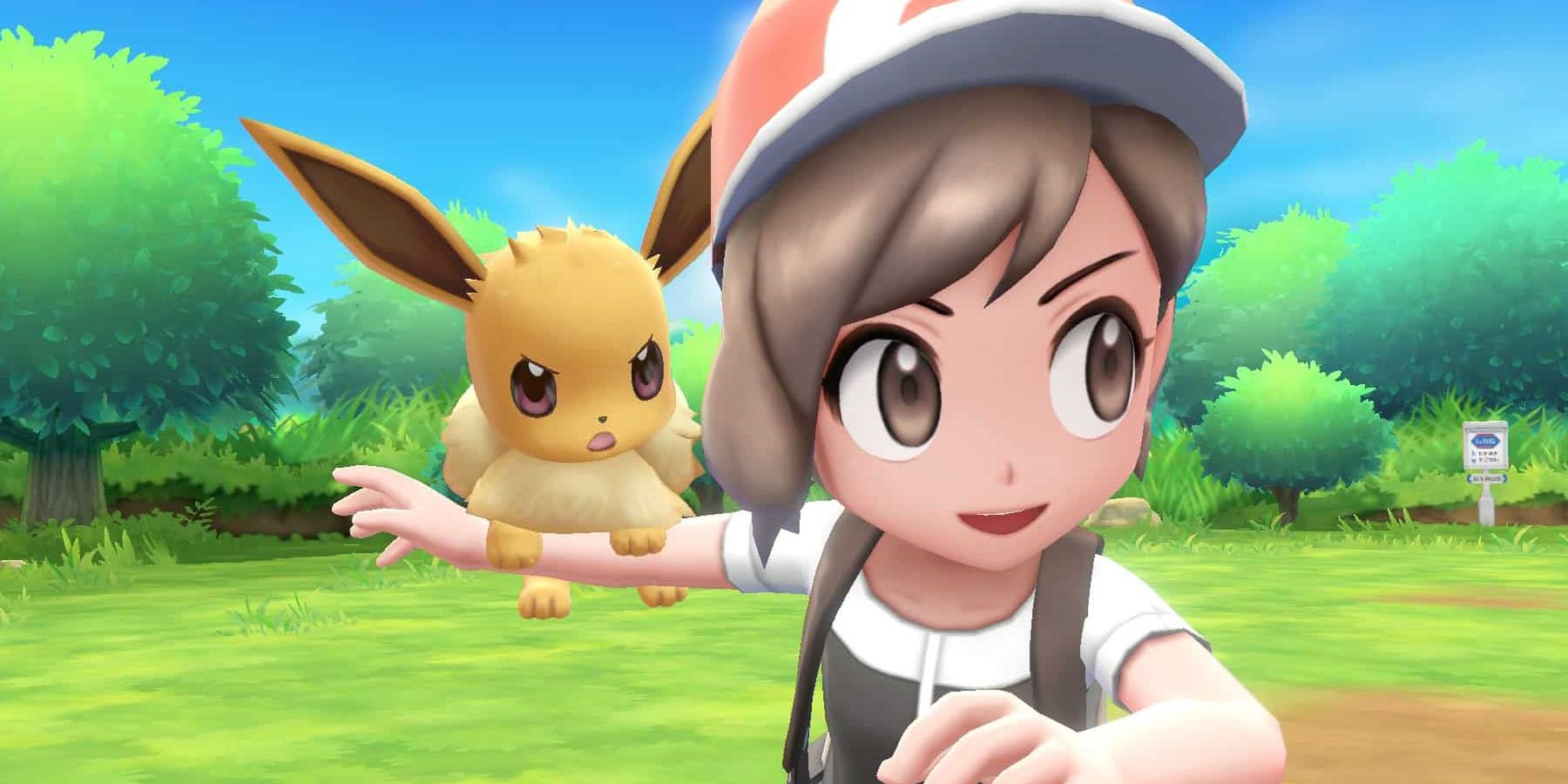 A screenshot of and Eevee standing on the arm of its trainer in Pokemon: Let's Go Eevee.