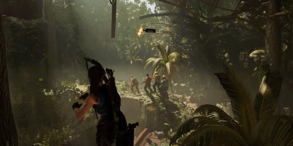 Lara throwing a molotov at a group of enemies 