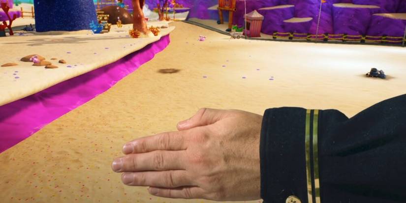 Live action hand with Bikini Bottom in the background in SpongeBob SquarePants: Battle for Bikini Bottom