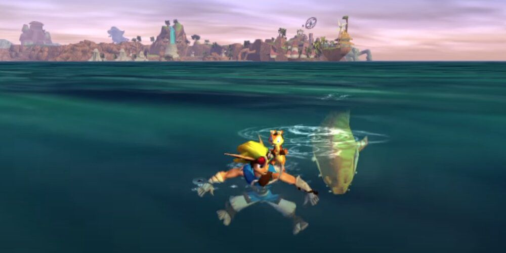 Jak swimming away from a yellow shark in Jak & Daxter: The Precursor Legacy 