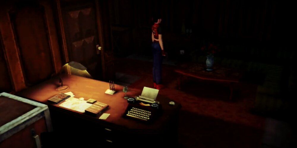 Claire standing in a dimly lit room with a messy table and typewriter in the foreground 