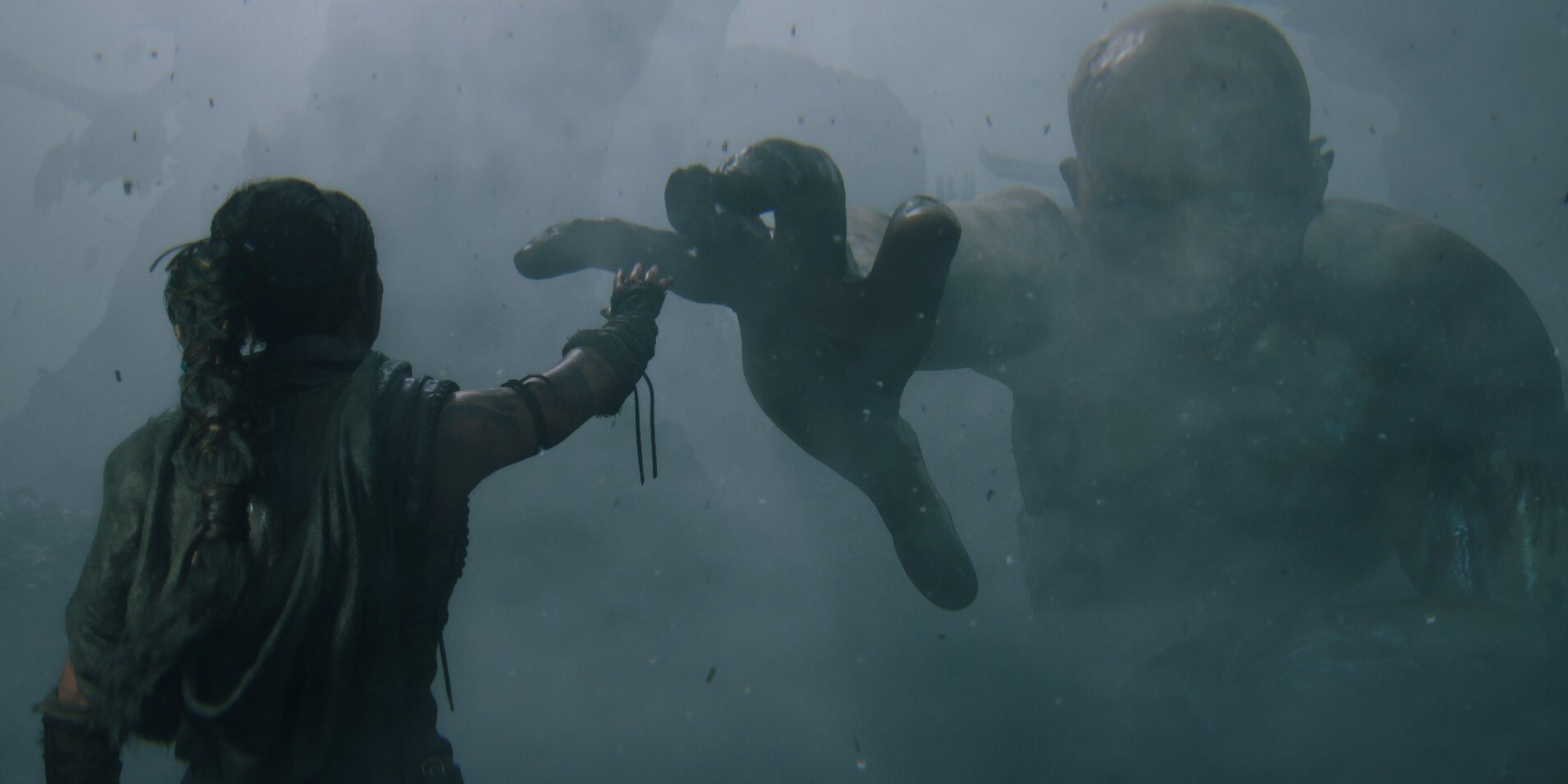 Hellblade 2 Senua Reaching Out To Touch A Drowned Giant