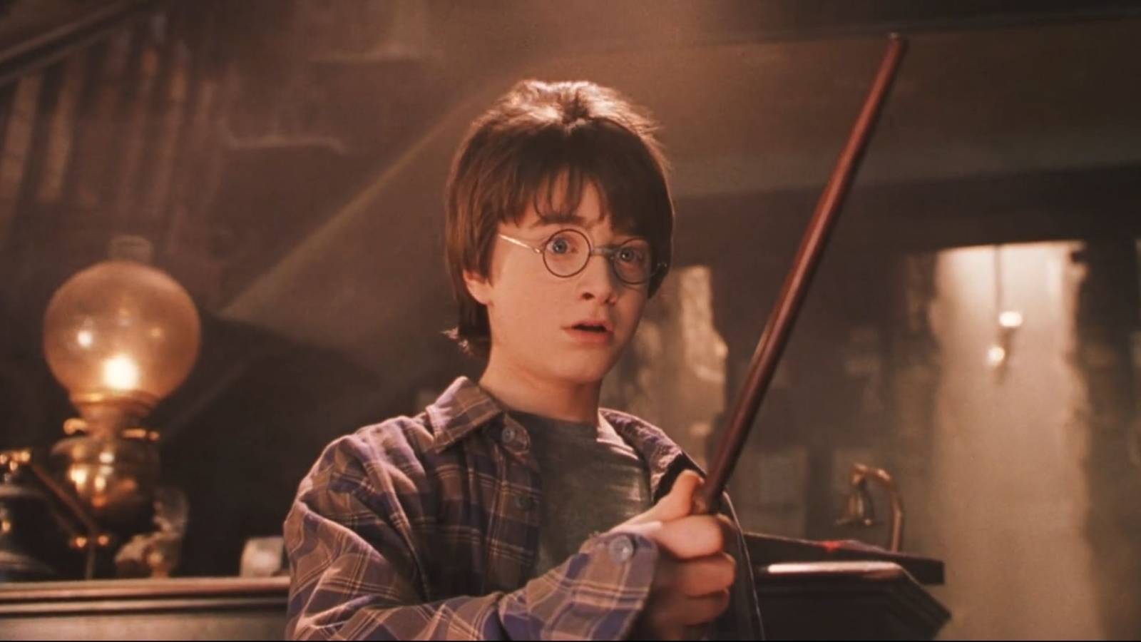 Harry Potter holding his wand for the first time