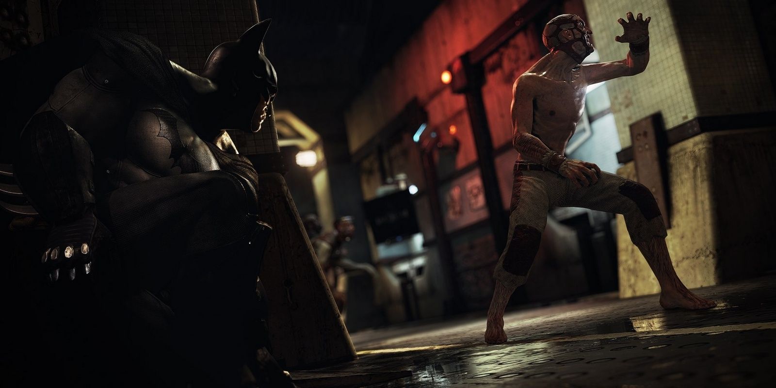 batman preparing to attack an enemy in arkham asylum