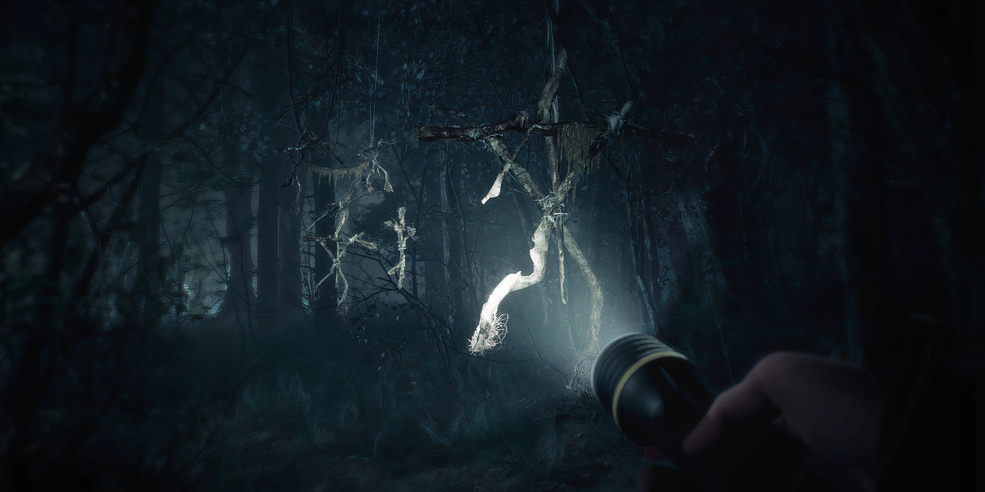 8 Great Folk Horror Video Games Shining a torch at creepy wooden effigies in the woods