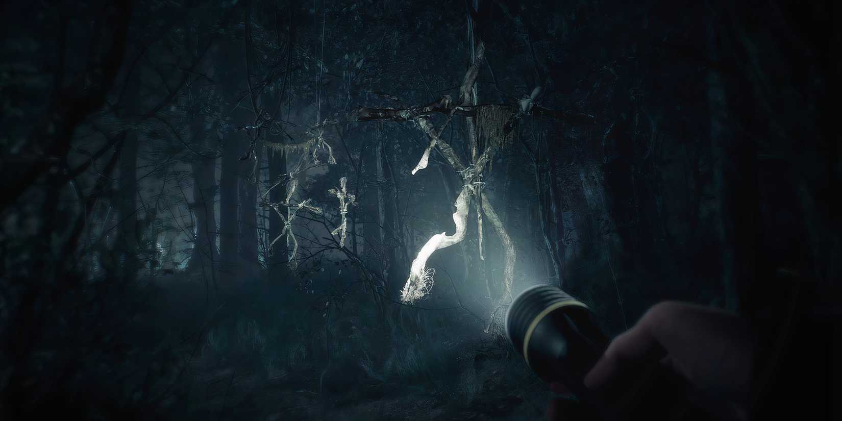 8 Great Folk Horror Video Games Shining a torch at creepy wooden effigies  in the woods