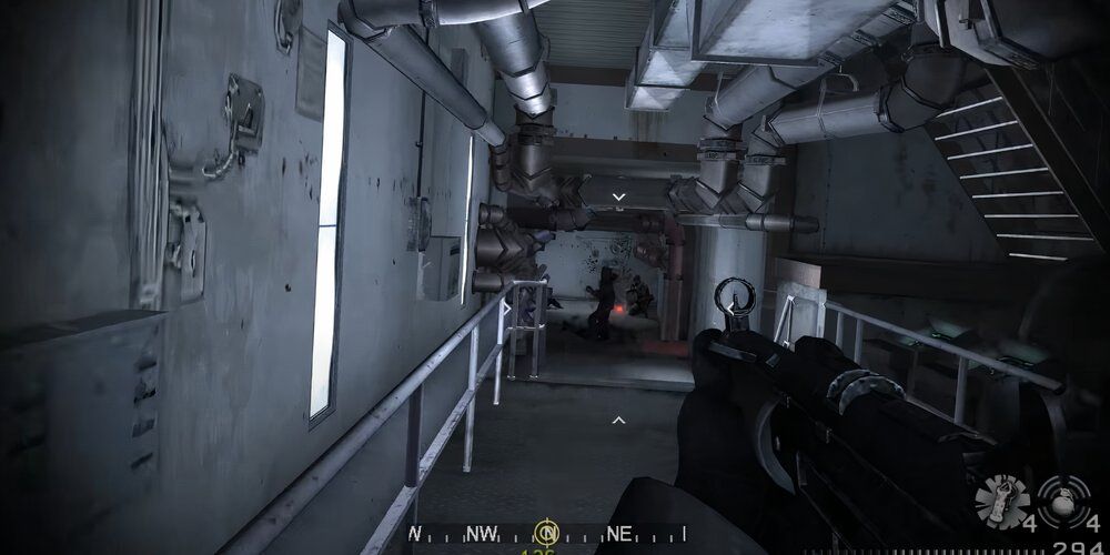 Player firing an MP5 at a group of enemies in a corridor 