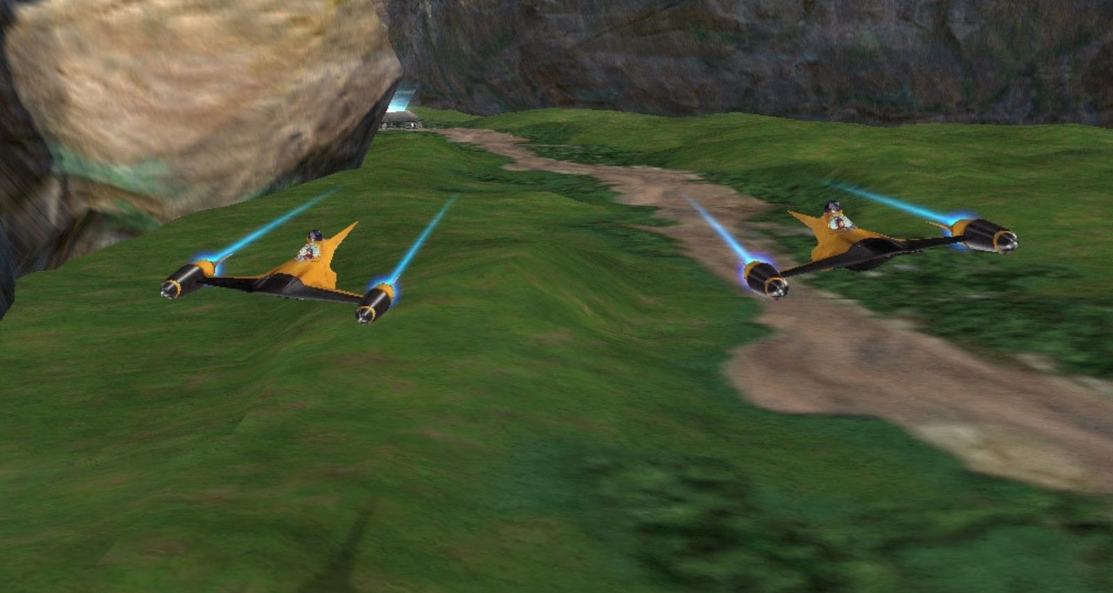 two naboo starfighters flying over grassy hills