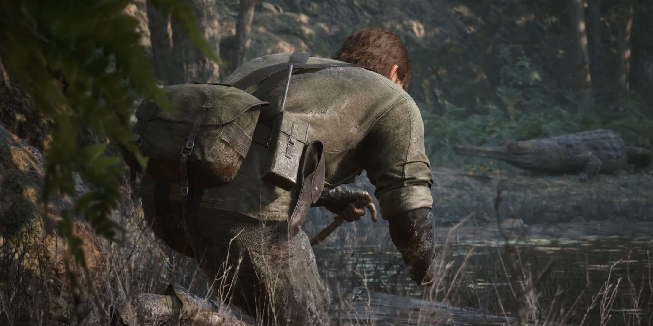 A screenshot of Naked Snake sneaking across a jungle in Metal Gear Solid Delta: Snake Eater.