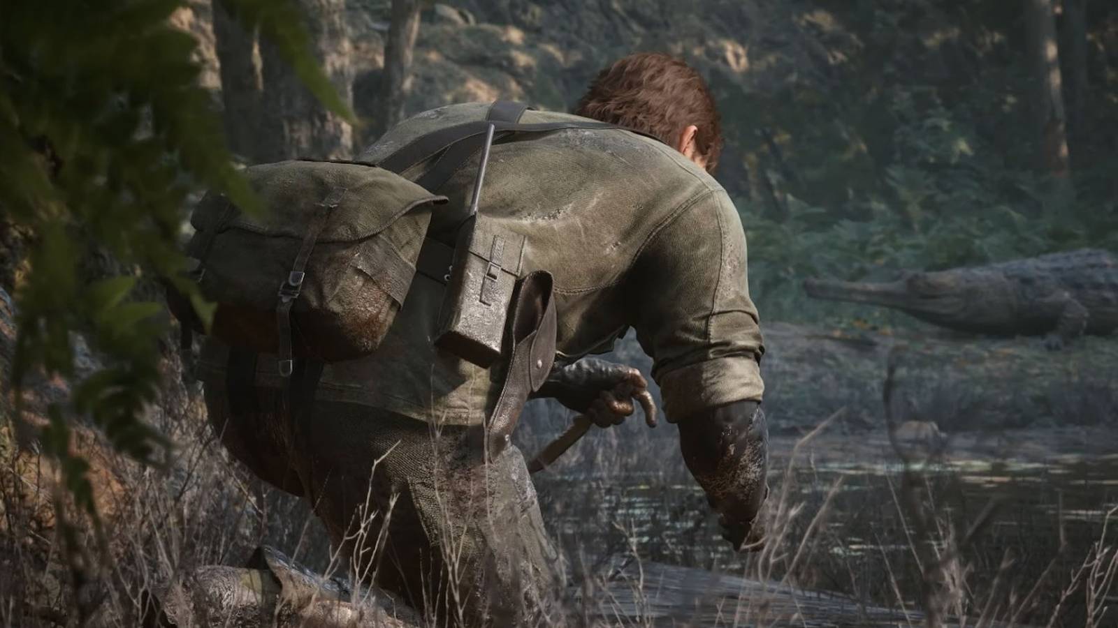 A screenshot of Naked Snake sneaking across a jungle in Metal Gear Solid Delta: Snake Eater.