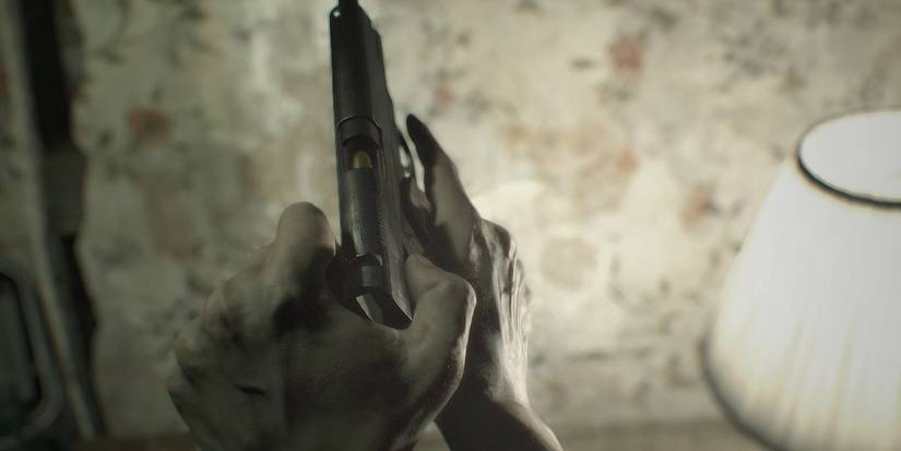 ethan reloading a weapon in re7