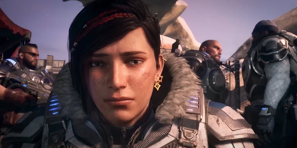 Kat looking concerned while other COGs are talking in the background in Gears of War 5