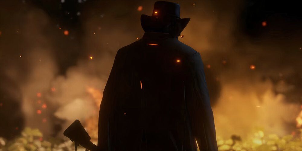 A silhouette of Arthur standing in front of flames