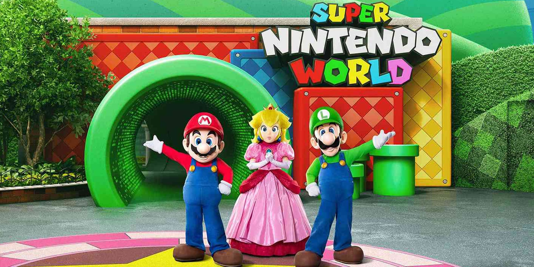 An image of Mario, Luigi, and Princess Peach greeting vistors at Super Nintendo World.