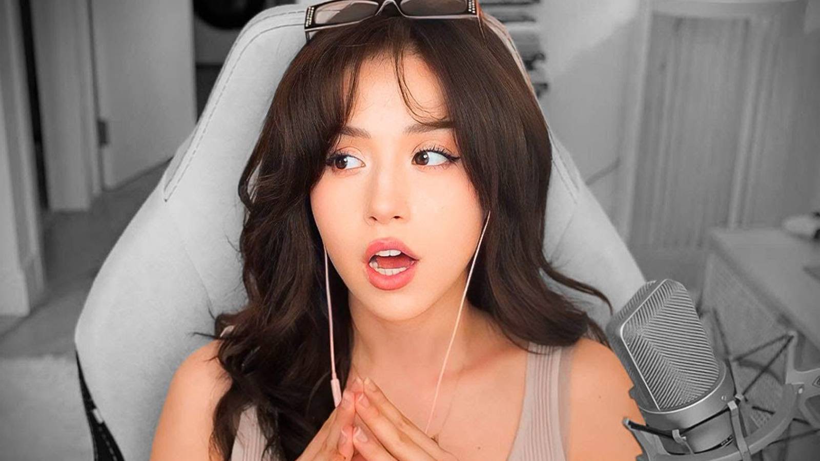 Pokimane looking surprised while sitting in a chair