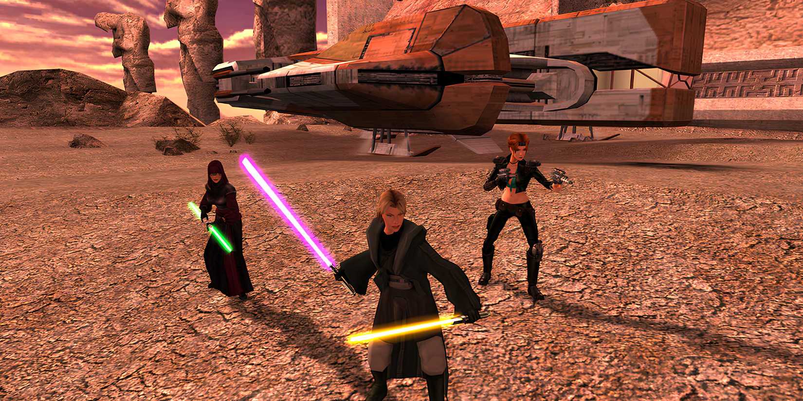 Three characters wielding lightsabers on a desert planet in Star Wars Knights of Old Republic 2
