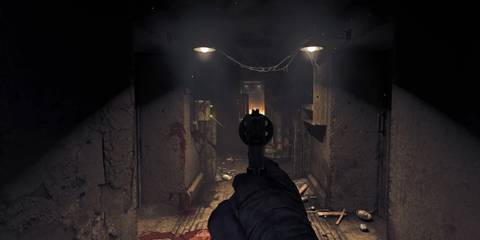 The player aiming a revolver down a long, vandalized corridor in Amnesia: The Bunker