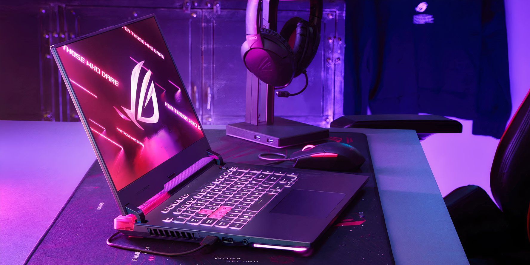 Asus ROG gaming laptop on a desk with headset