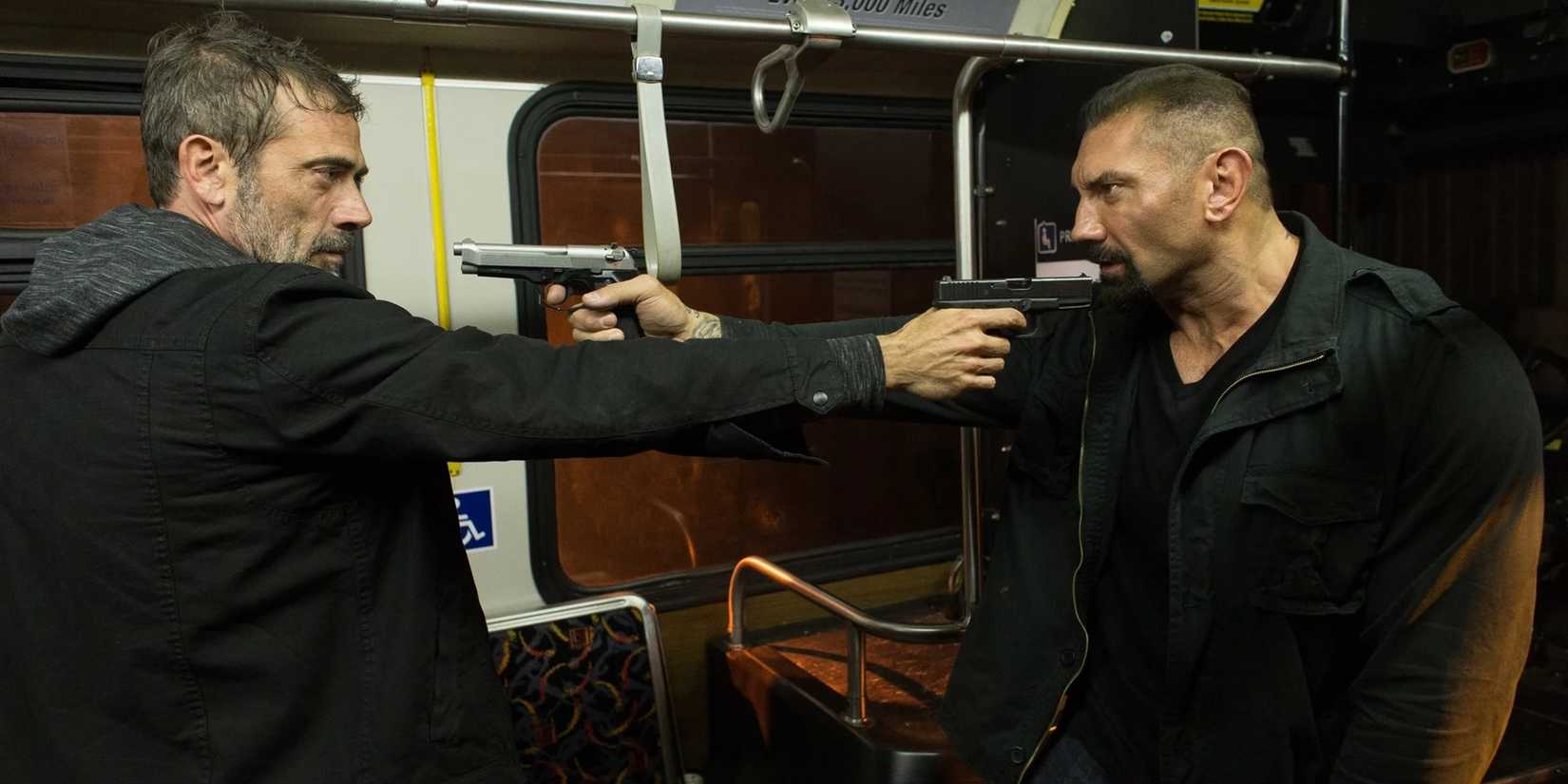 Dave Bautista holding a gun in Heist