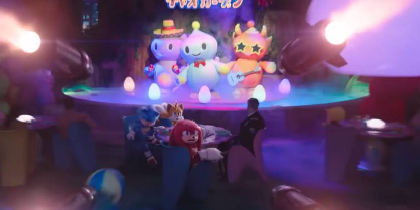 Sonic, Tails, Knuckles, and Commander Walters at a restaurant with Chao mascots on the stage. Sonic, Tails, and Knuckles notice missiles heading straight for them. Image source: Paramount Pictures