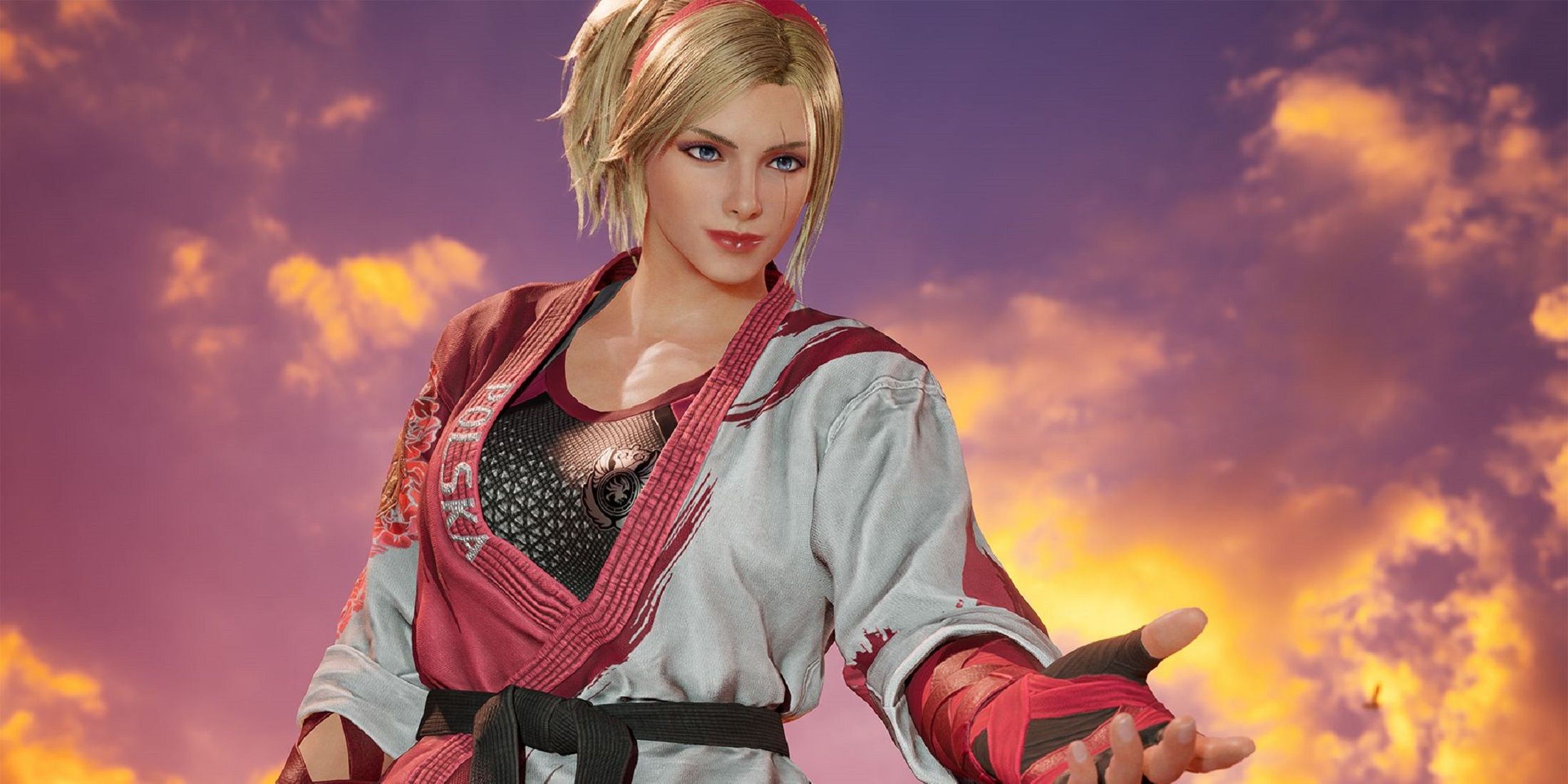 Lidia Sobieska from Tekken 8 stands confidently with an outstretched hand, wearing a red and white