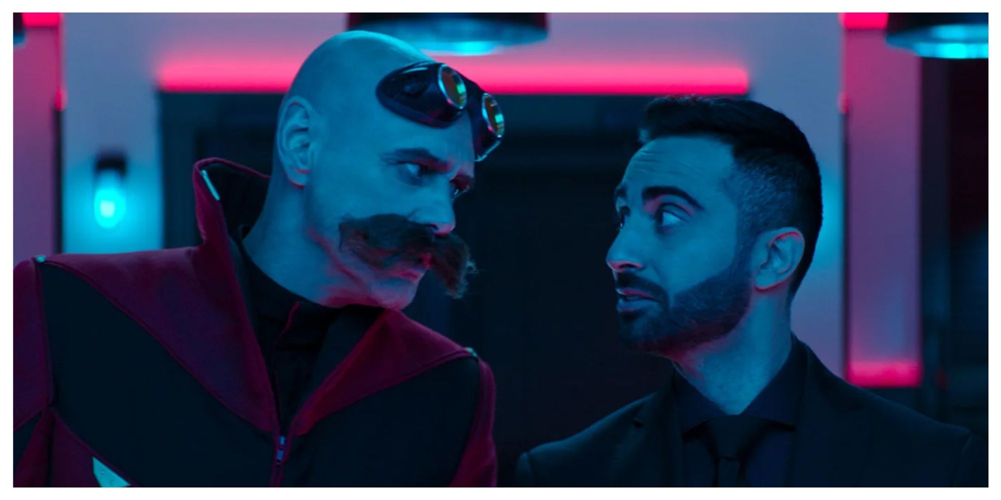 Robotnik (Jim Carrey) and Agent Stone (Lee Majdoub) staring at eachother