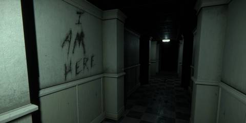 A long, dark corridor with the words 'I Am Here' written on the wall in The Mortuary Assistant
