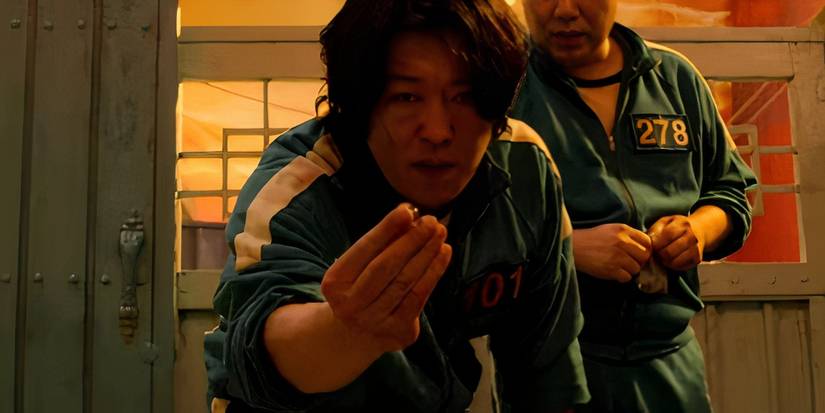 Jang Deok-su playing a marble game in Squid Game