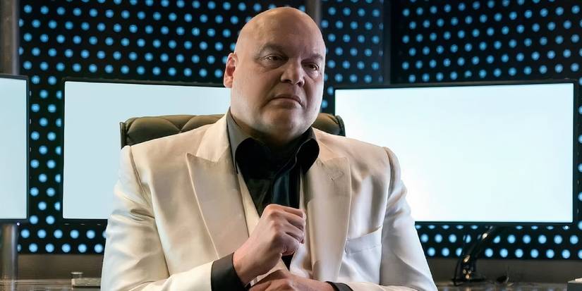 Kingpin White Suit Sitting Down In A Chair