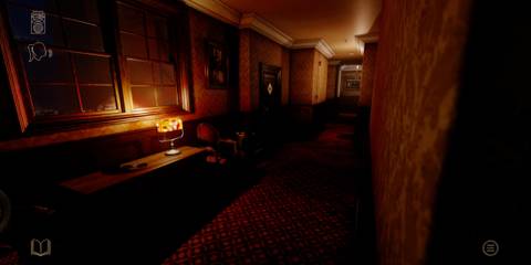 A dark corridor lit by a single lamp, stretching way into the distance