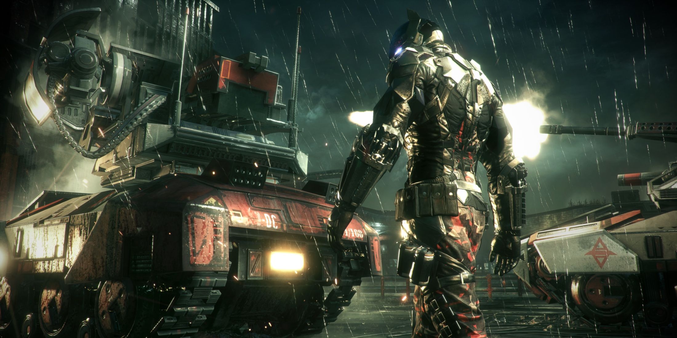 The Arkham Knight standing with his back turned next to a heavily armored vehicle