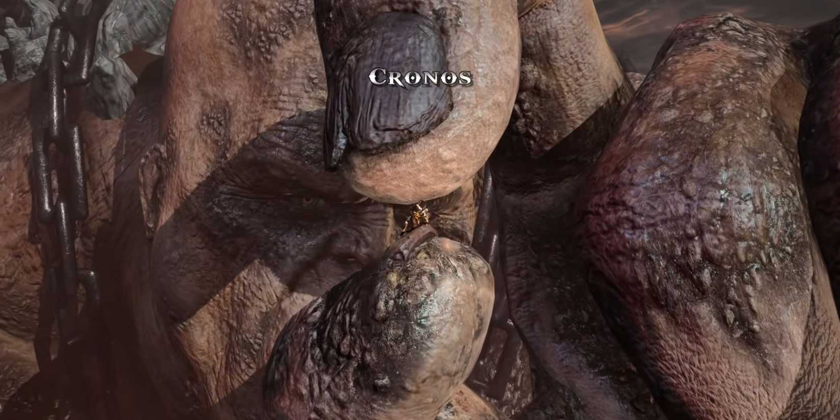 Cronos tries to crush Kratos with his fingers.