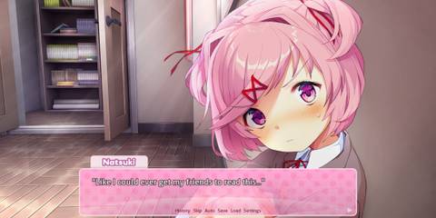 Natsuki sitting against a wall in the classroom talking about her manga collection