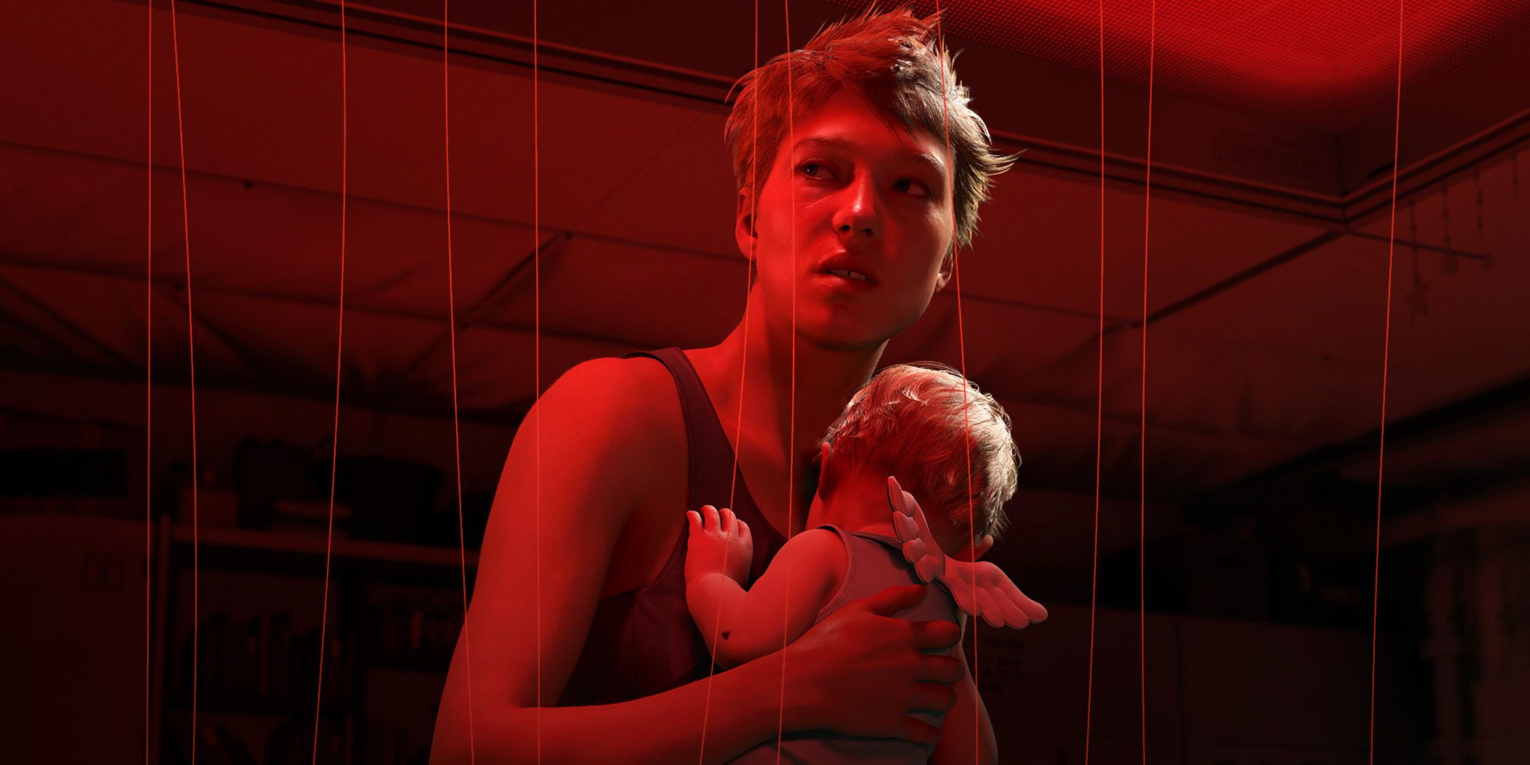 Death Stranding 2 On The Beach screenshot holding baby in red corridor