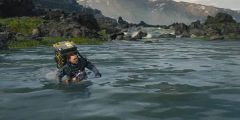 Sam Porter Bridges crossing a river in Death Stranding