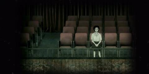 Girl sitting in an auditorium looking at camera in Detention